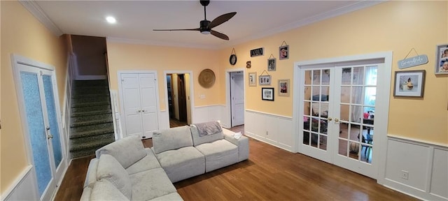 living room with wainscoting, french doors, crown molding, and ceiling fan