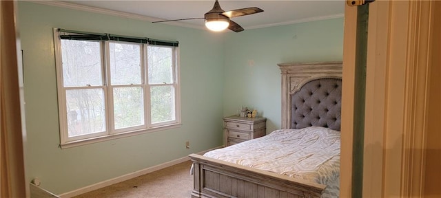 bedroom with crown molding, a ceiling fan, baseboards, and light carpet