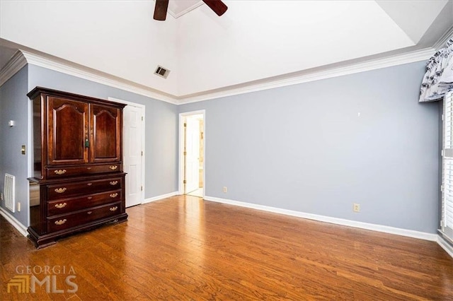 unfurnished bedroom featuring visible vents, dark wood-type flooring, baseboards, and ornamental molding