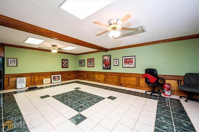 office with tile patterned floors, wainscoting, crown molding, and a ceiling fan