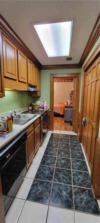 kitchen with dishwasher, crown molding, brown cabinetry, and under cabinet range hood