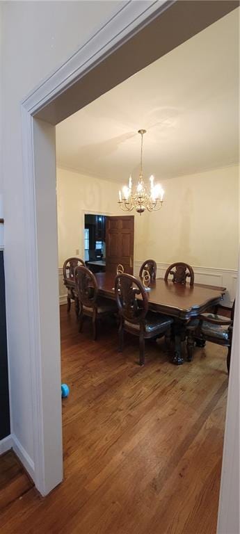 dining area featuring a notable chandelier and wood finished floors