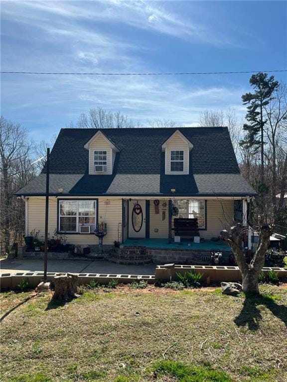 view of front of house with cooling unit and a front yard