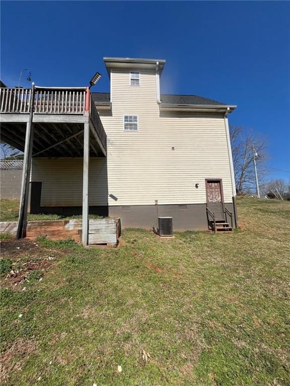 back of property with entry steps, central AC, a yard, crawl space, and a wooden deck