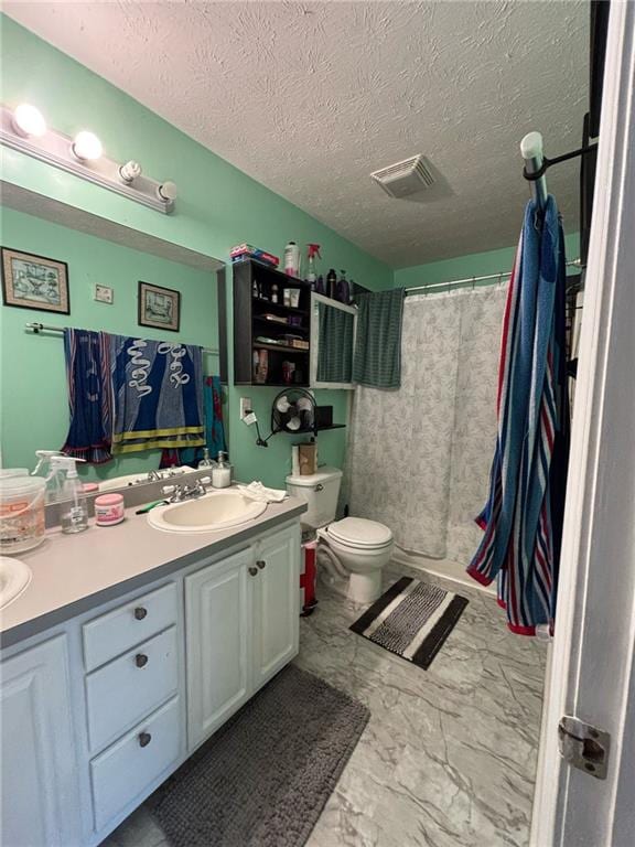 full bathroom featuring marble finish floor, toilet, vanity, a textured ceiling, and a shower with curtain