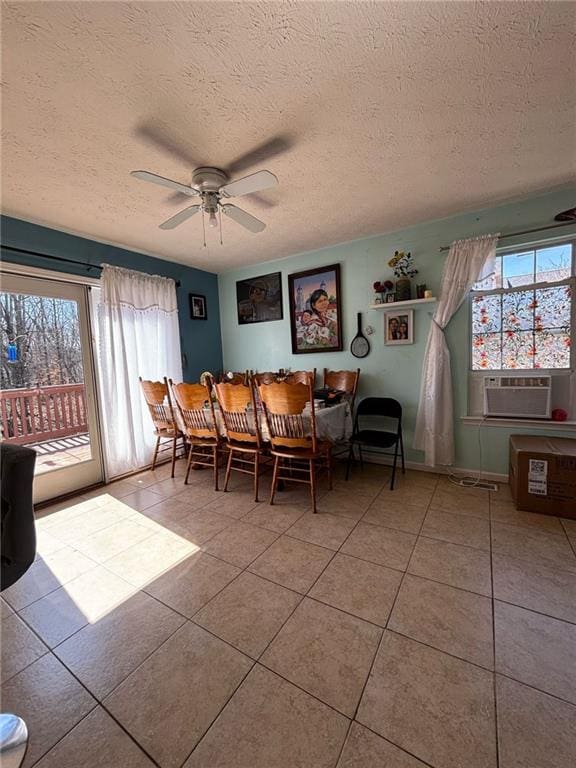 unfurnished dining area featuring tile patterned flooring, a textured ceiling, ceiling fan, and cooling unit