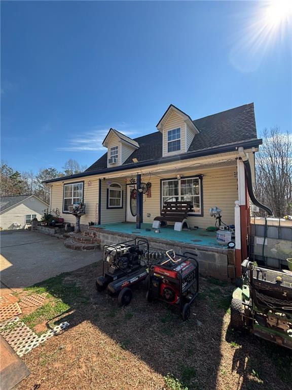 cape cod home with a porch