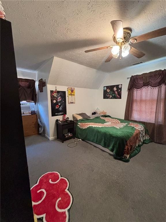 bedroom featuring carpet, lofted ceiling, visible vents, ceiling fan, and a textured ceiling