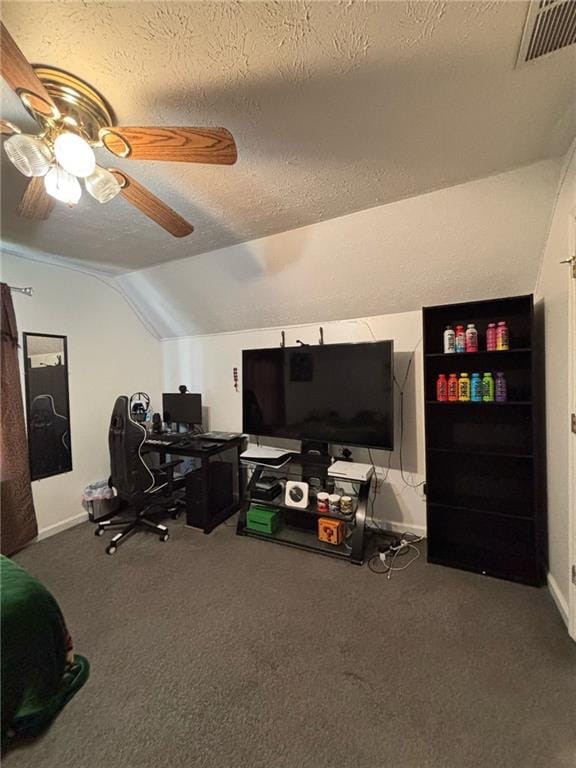 carpeted home office featuring baseboards, visible vents, lofted ceiling, ceiling fan, and a textured ceiling