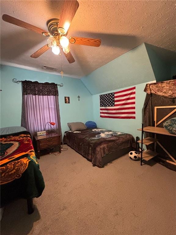 bedroom featuring lofted ceiling, ceiling fan, a textured ceiling, and carpet flooring