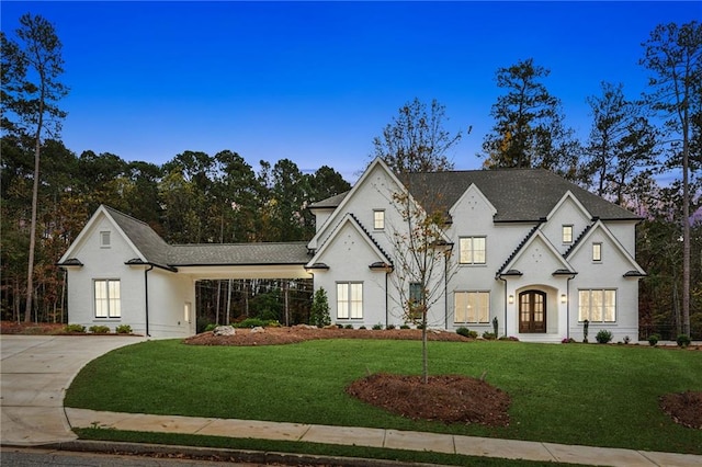 view of front facade featuring french doors and a front lawn