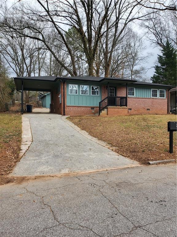 single story home featuring a carport