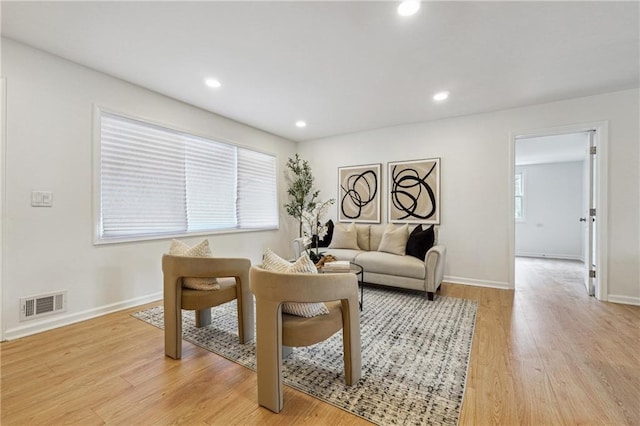 interior space featuring baseboards, light wood-type flooring, visible vents, and recessed lighting