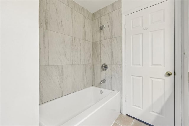 bathroom featuring tiled shower / bath combo and tile patterned flooring