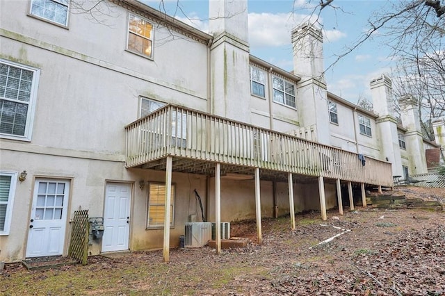 back of property featuring central AC