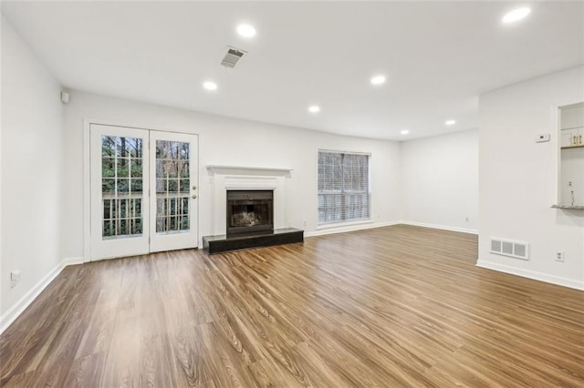 unfurnished living room featuring wood-type flooring