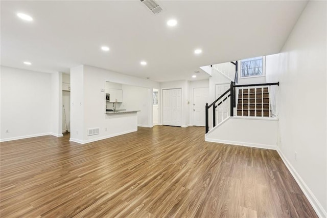 unfurnished living room with hardwood / wood-style flooring