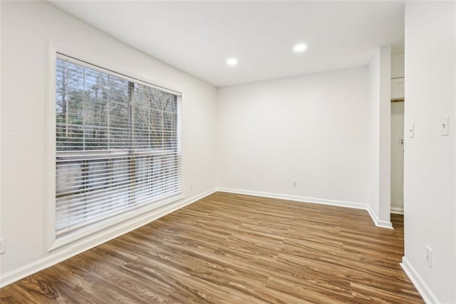 unfurnished room featuring hardwood / wood-style flooring