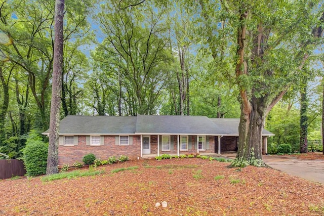 333 Lynne Cir, Alpharetta, GA 30009 - ranch-style home with brick siding, driveway, a porch, and an attached carport