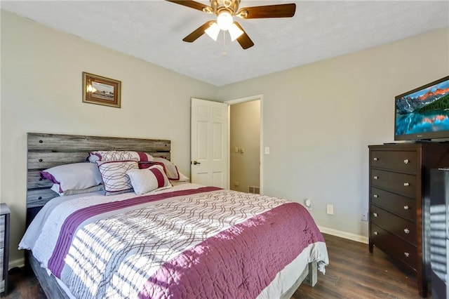 bedroom featuring dark wood finished floors, baseboards, and ceiling fan