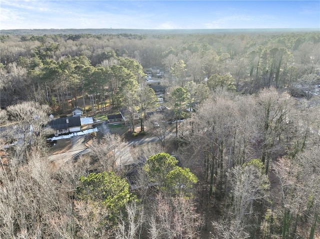 aerial view featuring a wooded view