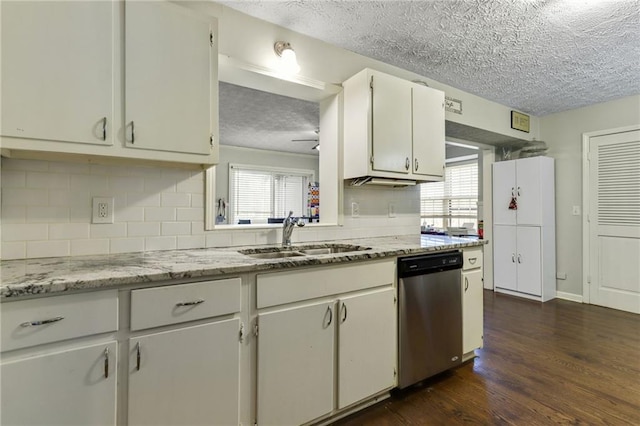 kitchen with a sink, a wealth of natural light, white cabinets, and stainless steel dishwasher