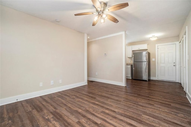 unfurnished living room with ceiling fan and dark hardwood / wood-style floors