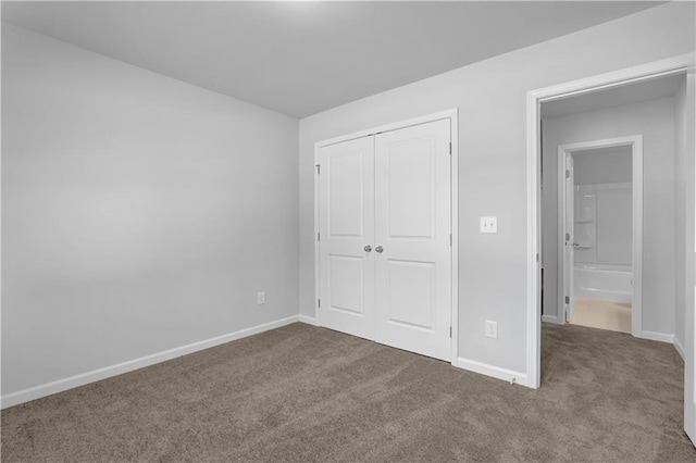 unfurnished bedroom featuring carpet flooring and a closet