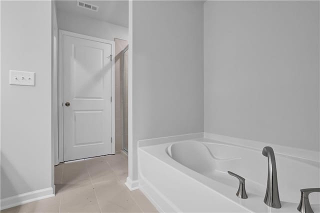 bathroom with independent shower and bath and tile patterned flooring