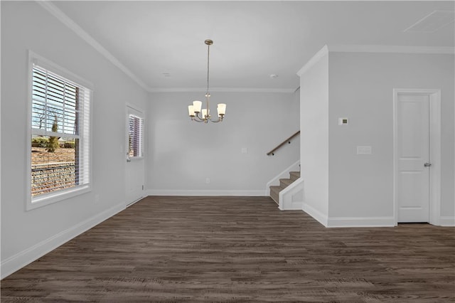 spare room with crown molding, dark hardwood / wood-style flooring, and a chandelier