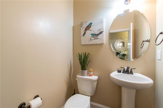 12275 Styron Dr, Hampton, GA 30228 - half bathroom featuring toilet, baseboards, and a sink