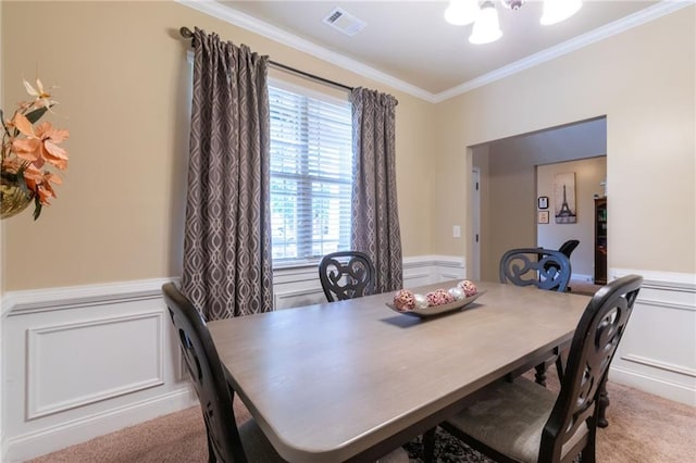 12275 Styron Dr, Hampton, GA 30228 - dining space featuring crown molding, a chandelier, a wainscoted wall, a decorative wall, and light colored carpet