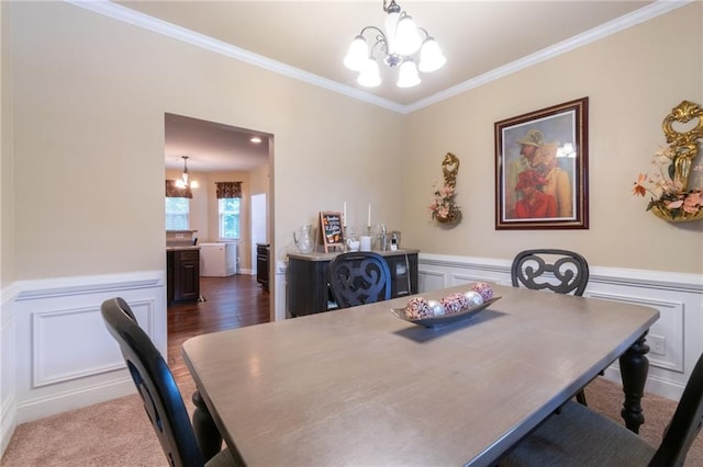 12275 Styron Dr, Hampton, GA 30228 - dining area featuring a chandelier, ornamental molding, a decorative wall, wainscoting, and wood finished floors