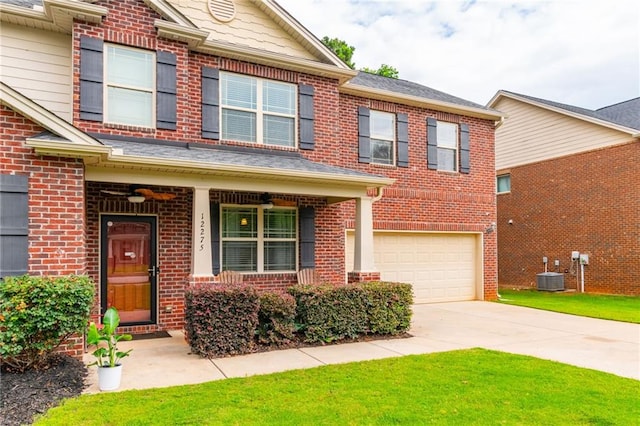 12275 Styron Dr, Hampton, GA 30228 - view of property featuring a garage, brick siding, central AC, driveway, and a front yard