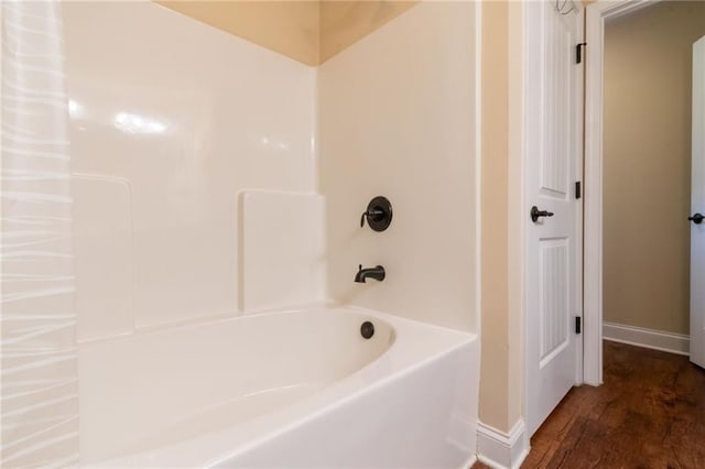 12275 Styron Dr, Hampton, GA 30228 - bathroom with baseboards, wood finished floors, and  shower combination