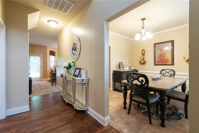 12275 Styron Dr, Hampton, GA 30228 - dining space with dark wood-style floors, a chandelier, baseboards, and crown molding