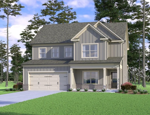 craftsman-style house featuring board and batten siding, an attached garage, driveway, and a front lawn
