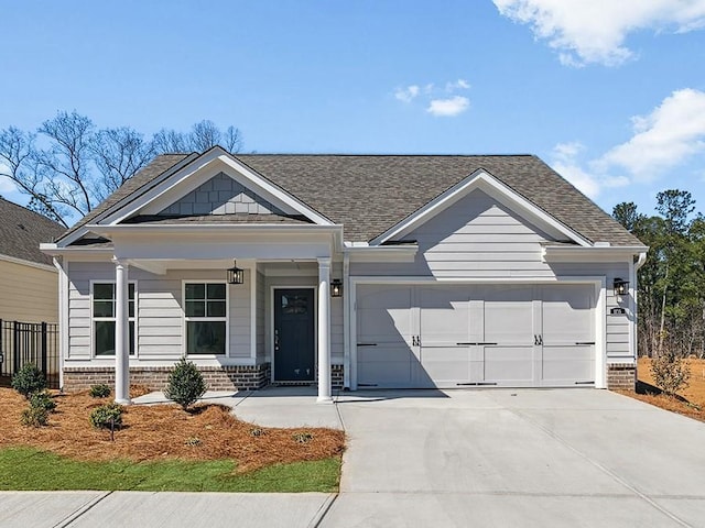 view of front of house featuring a garage, brick siding, roof with shingles, and driveway