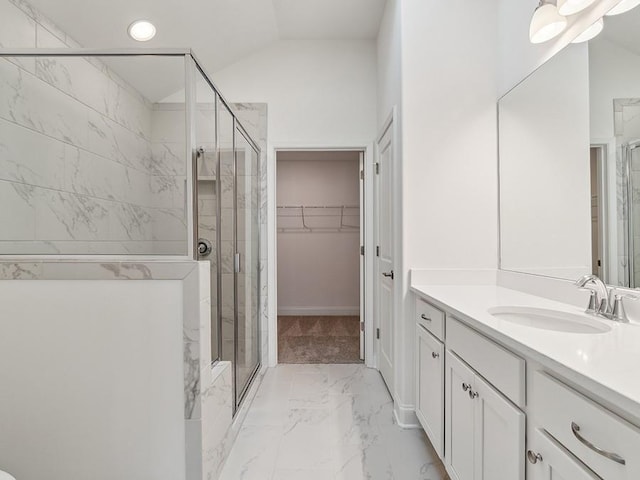 full bath featuring marble finish floor, a stall shower, lofted ceiling, a spacious closet, and vanity