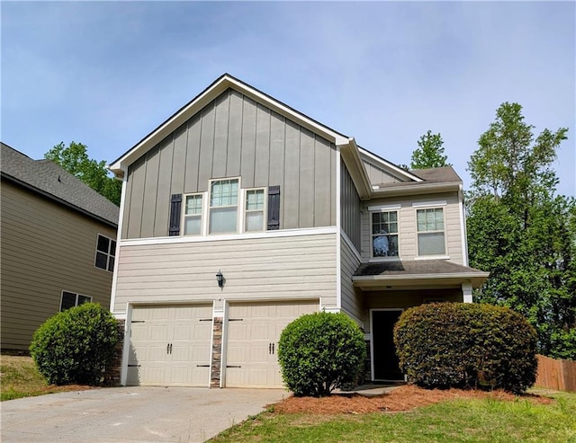 view of front of property with board and batten siding, a garage, and concrete driveway