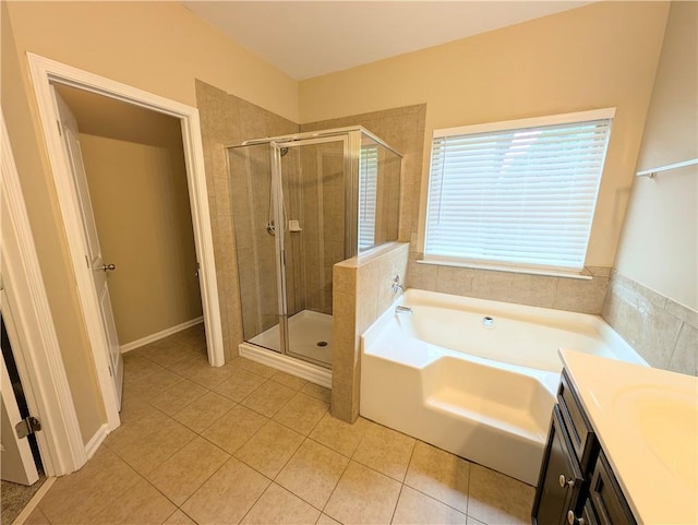 bathroom with tile patterned flooring, a shower stall, a garden tub, and vanity