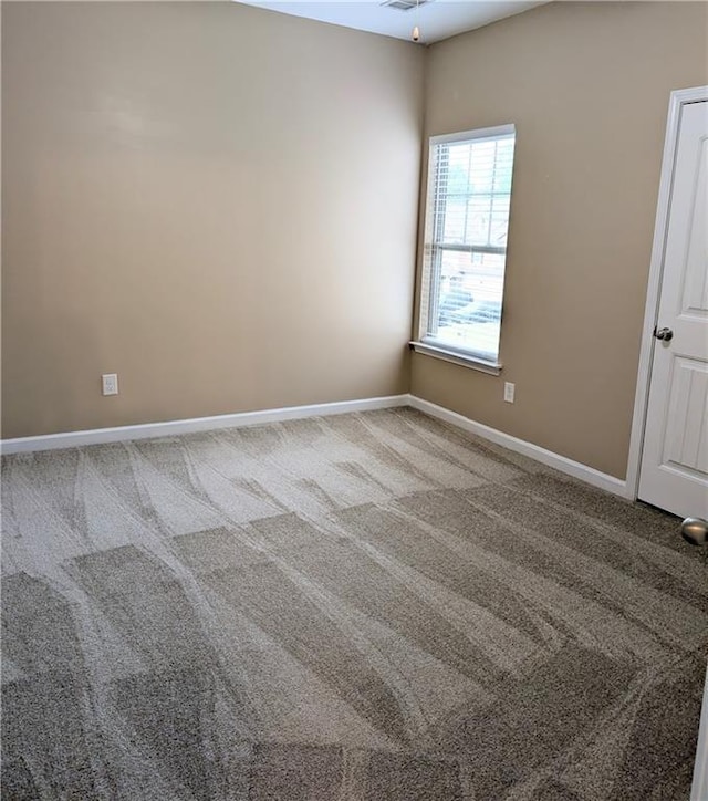 carpeted empty room featuring baseboards and ceiling fan