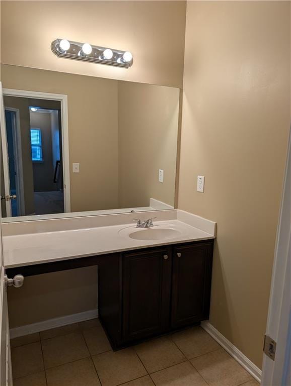 bathroom with tile patterned flooring, vanity, and baseboards