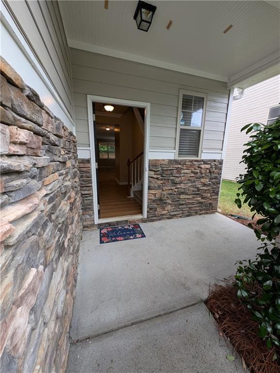 doorway to property with stone siding