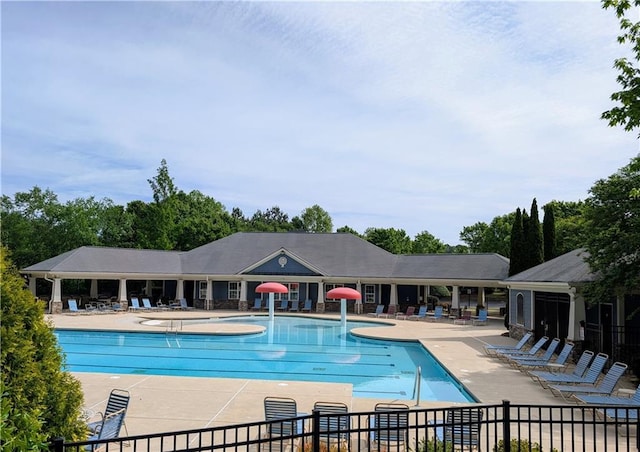 community pool featuring a patio and fence