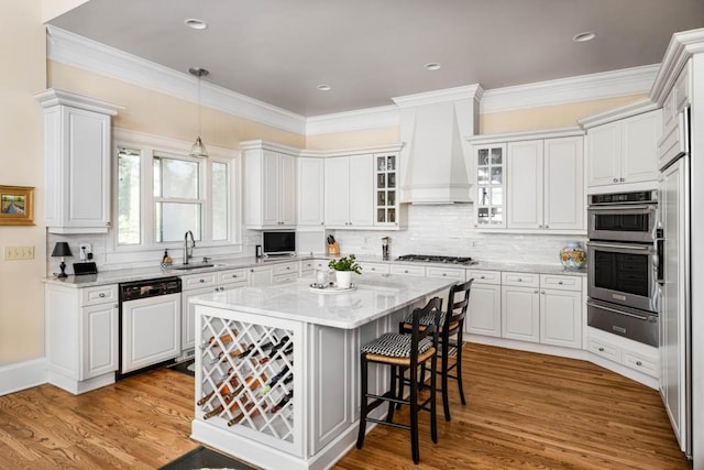 803 Night Fire Dr, Dawsonville, GA 30534 - kitchen with a sink, a warming drawer, stainless steel appliances, custom range hood, and a kitchen bar