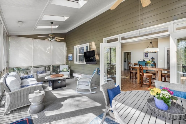 803 Night Fire Dr, Dawsonville, GA 30534 - sunroom with a healthy amount of sunlight, an outdoor living space with a fire pit, a skylight, and ceiling fan