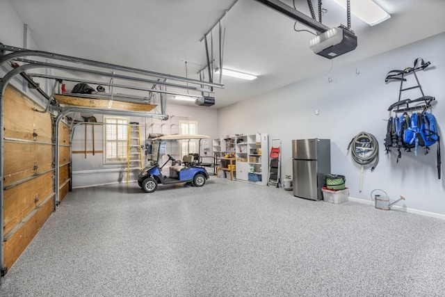 803 Night Fire Dr, Dawsonville, GA 30534 - garage featuring freestanding refrigerator and a garage door opener