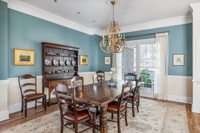 803 Night Fire Dr, Dawsonville, GA 30534 - dining area with light wood-style floors, crown molding, baseboards, and an inviting chandelier