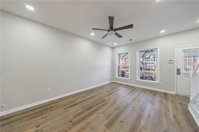 empty room with recessed lighting, visible vents, ceiling fan, wood finished floors, and baseboards